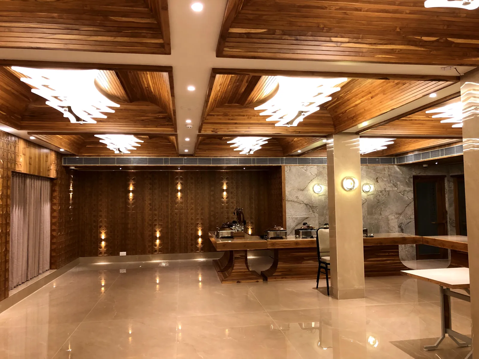 AC banquet hall with coffered wooden ceiling and chandeliers
